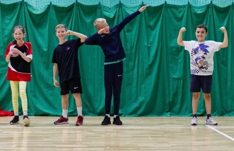 Swim coach helping with swim cap